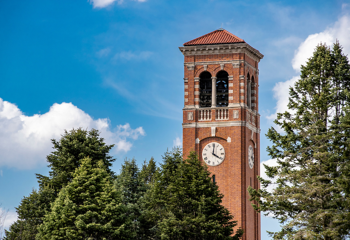 View of the UNI campanile with blue sky and white clouds in the background