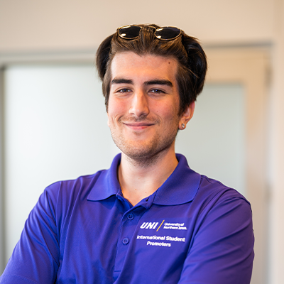 Berkay C. smiling in a purple UNI polo