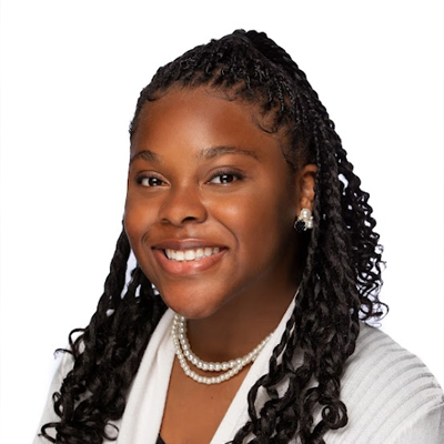 Studio headshot of Diamond smiling on a white background
