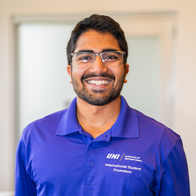 Gavik K. smiling in a purple UNI polo
