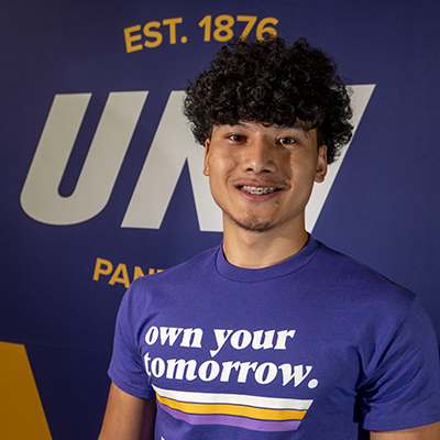 Pee Soe smiling in a purple t-shirt that reads "own your tomorrow."