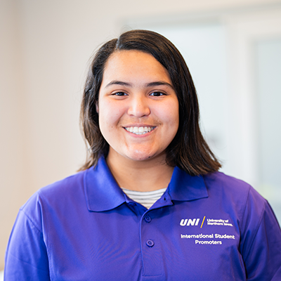 Salma S. smiling in a purple UNI polo