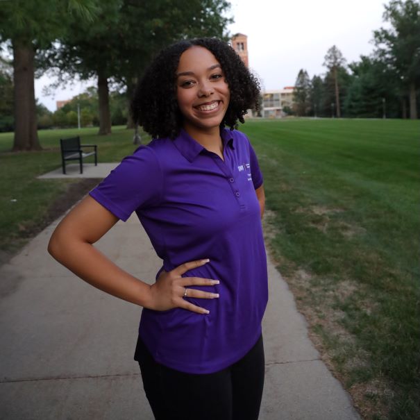 Celia wearing purple polo