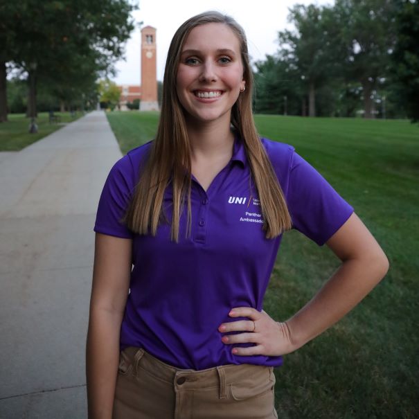 Claire wearing purple polo