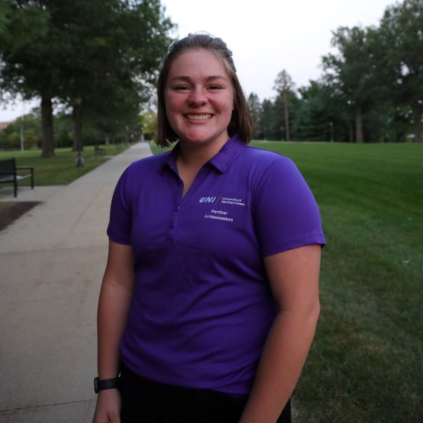 Claire wearing purple polo