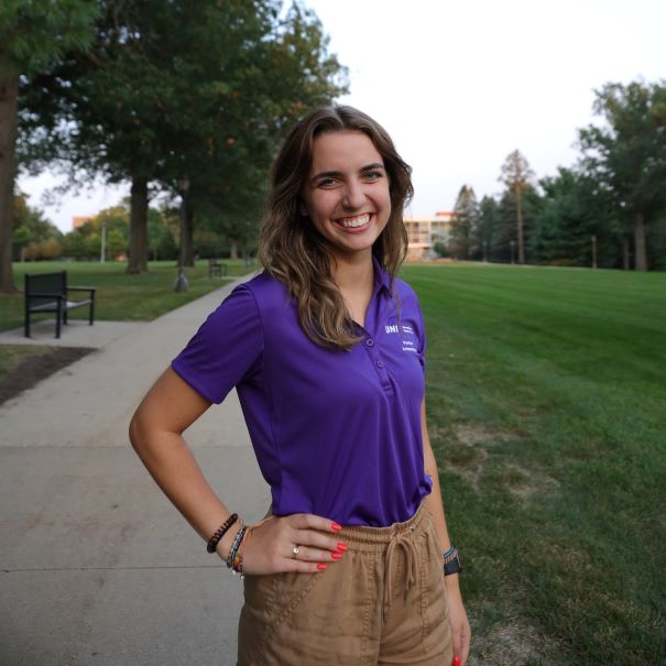 Emily wearing purple polo