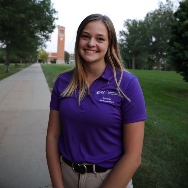 Emma wearing purple polo