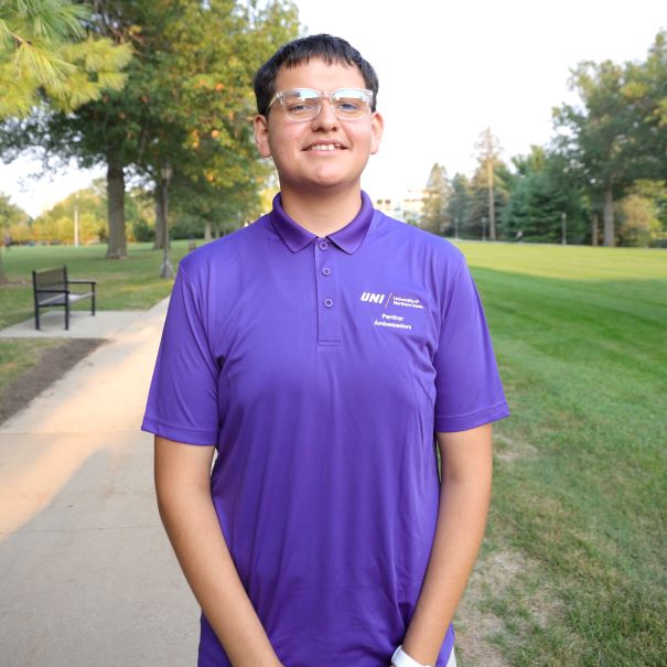 Favian wearing purple polo