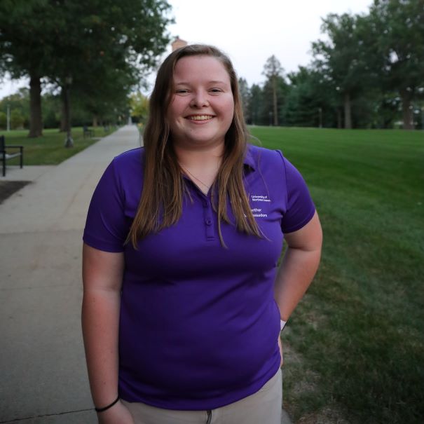 Kaitlyn wearing a purple polo