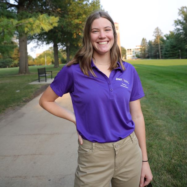 Lydia wearing a purple polo 