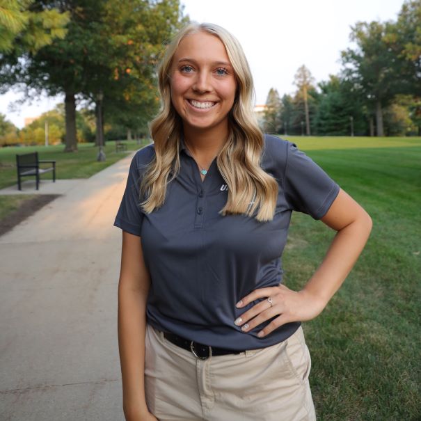 Marah wearing a grey polo