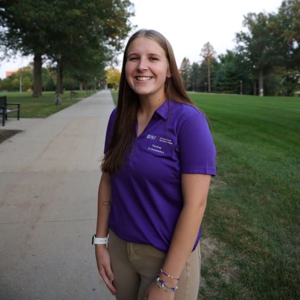 Shelby wearing a purple polo