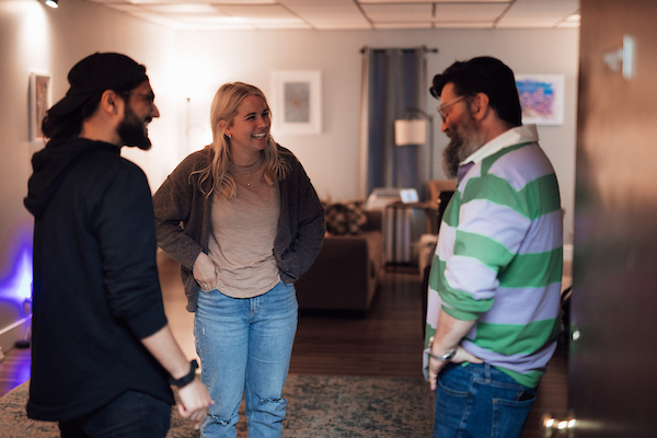 Three graduate students laughing