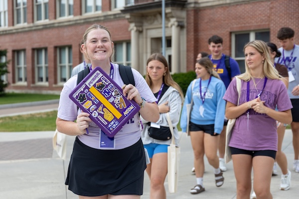 UNI student leader taking a group of students around campus for Orientation.