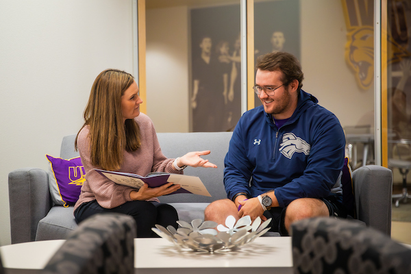 UNI transfer counselor sitting with a student.