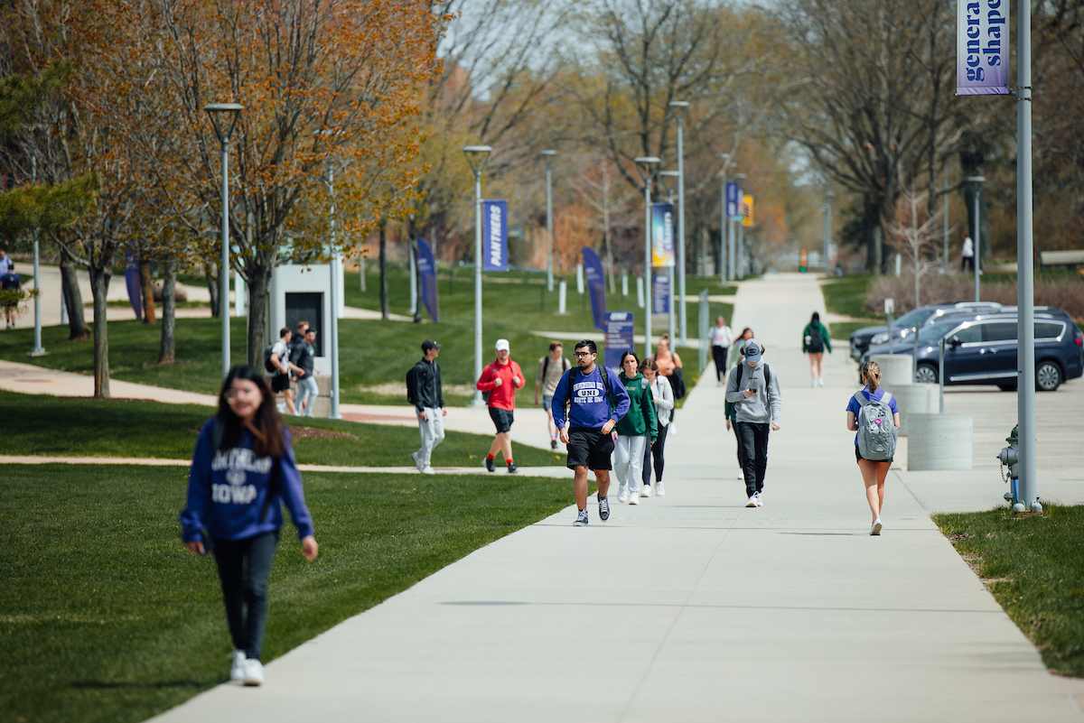 Students walking down sidewalk on campus