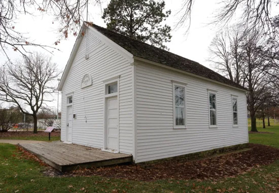 Photo of the historic Marshall Center School, a white 1920s-era schoolhouse