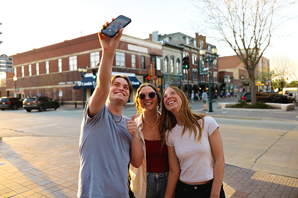 UNI students taking photo in downtown Cedar Falls